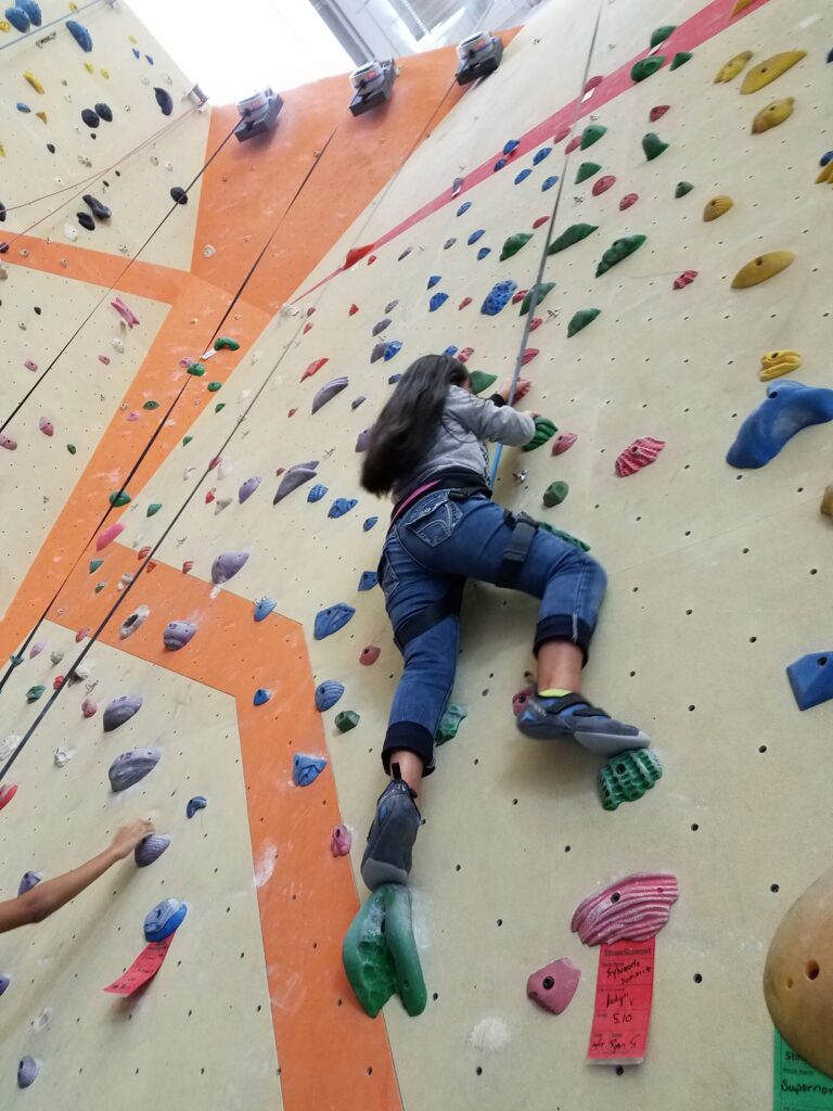 Image of blind climber on rock wall.